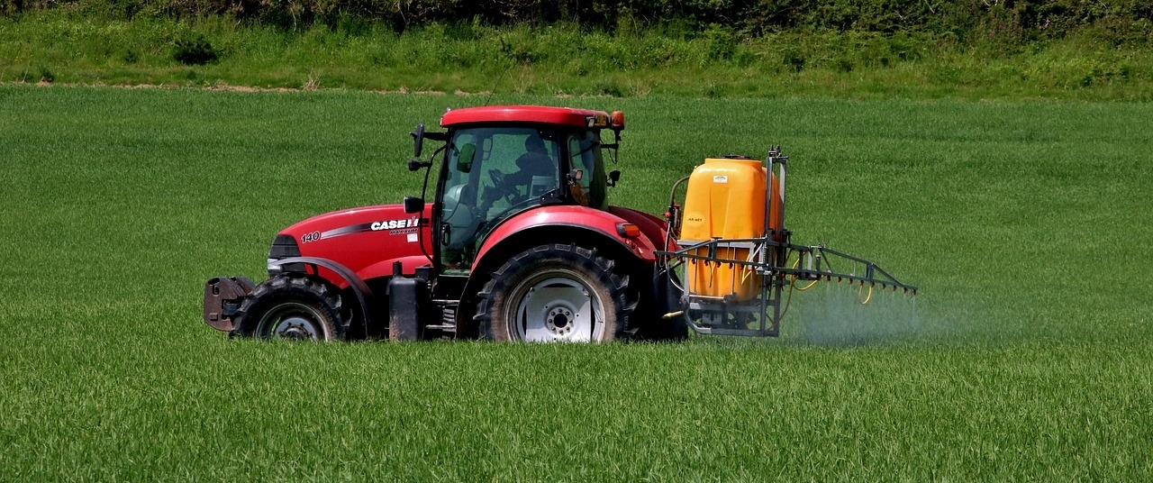 Tractor spraying a crop for weeds